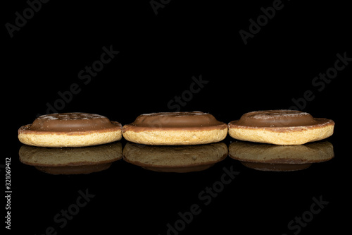 Group of three whole chocolate biscuit isolated on black glass