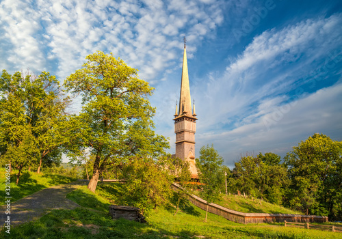 Traditional Maramures wooden church. UNESCO world heritage site. Surdesti, Maramures, Romania photo