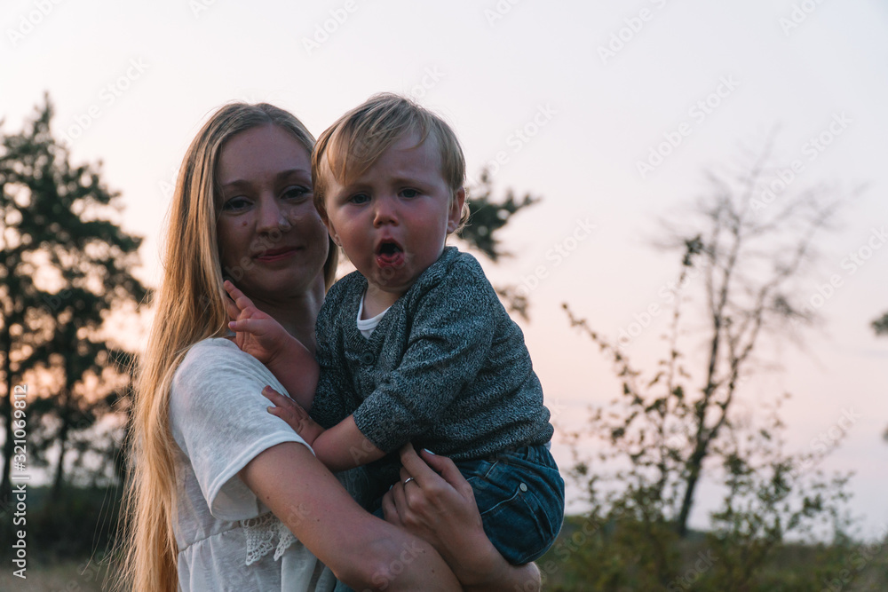 Family portrait of mother and her young son in the park. Family leisure outdoors in the natural landscape