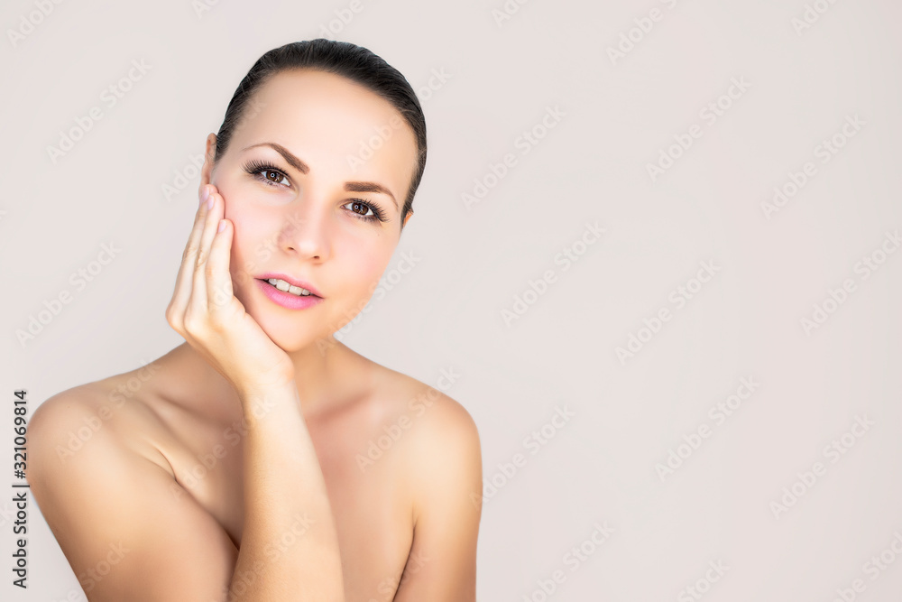 Young woman, beautiful female smiling on an isolated white background. Beauty concept: natural youth, body care, radiant facial skin. Copy space Young woman, beautiful female smiling on an isolated white background. Beauty concept: natural youth, body care, radiant facial skin. Copy space