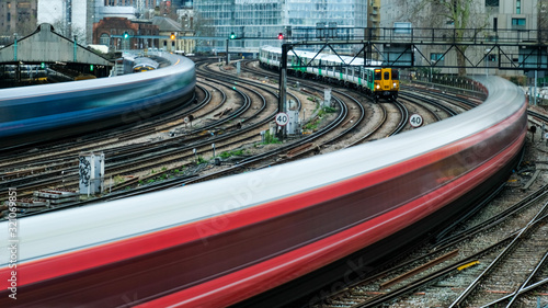 Motion blurred trains arriving on to railway station