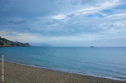 Obraz na płótnie Sea coast. Sandy beach overlooking the mountain range and the horizon. Thick clouds. Black Sea w salonie