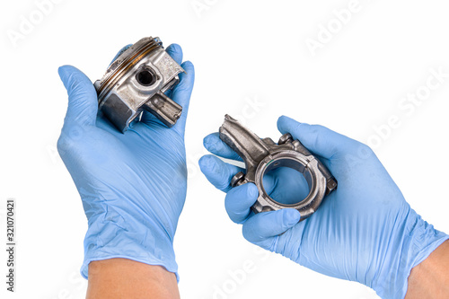 Piston and connecting rod  damage in hand isolated on white background  with clipping path