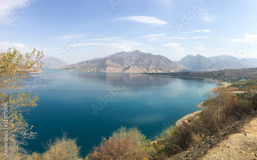 Fototapeta Naklejka Na Ścianę i Meble -  Beautiful panaorama view of blue water of the Chimgan Lake, Uzbekistan 