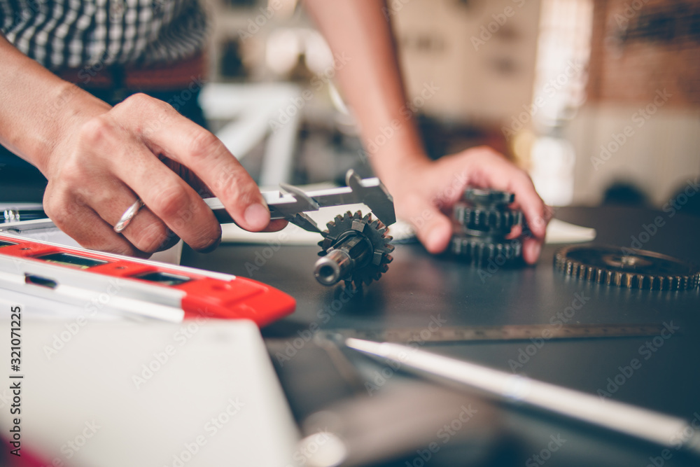 Mechanical engineers are working on the caliper to measure the gear. To design the machine Mechanical engineers are working on the caliper to measure the gear. To design the machine