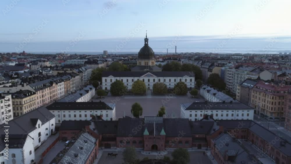 Drone shot flying over rooftops of Stockholm at dawn. Aerial view of Östermalm district, church tower, apartment buildings and courtyard. Capital city of Sweden, cityscape skyline Drone shot flying over rooftops of Stockholm at dawn. Aerial view of Östermalm district, church tower, apartment buildings and courtyard. Capital city of Sweden, cityscape skyline