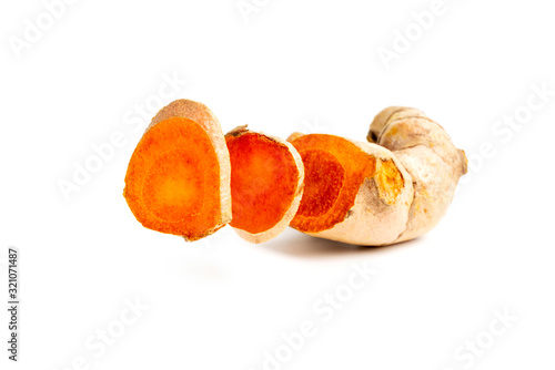 Cutting of turmeric curcumin root on isolated white background.