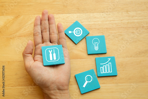 Canvas Print Hand with Business tools symbol
