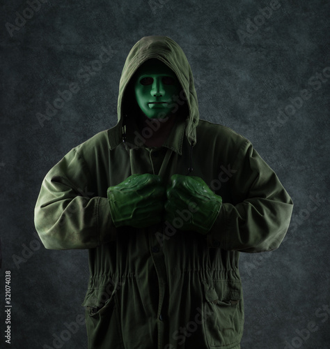 masked green man in a hood