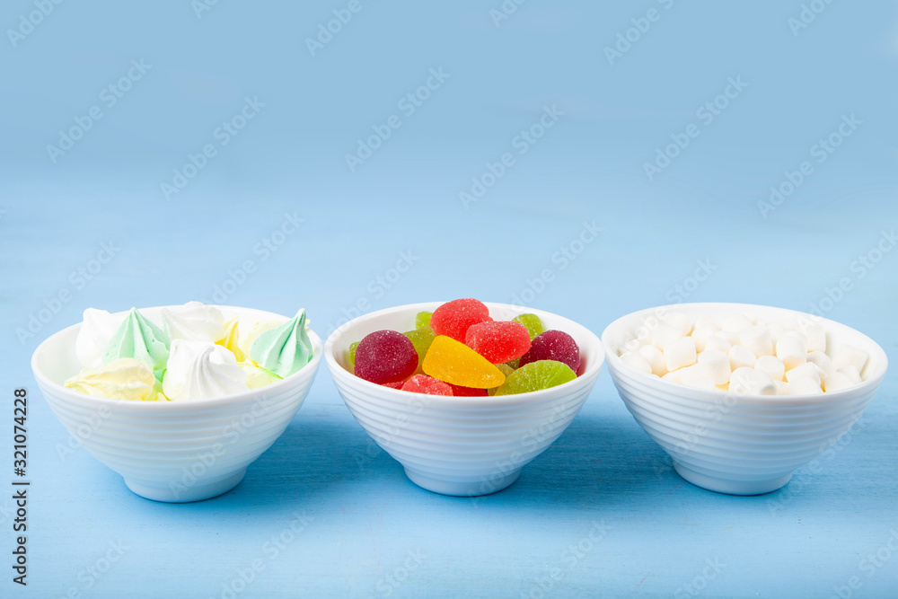 Meringue,marmalade and marshmallow in white bowls Meringue,marmalade and marshmallow in white bowls