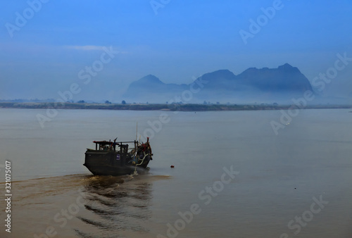 A boat is traveling to dramatic land through the river