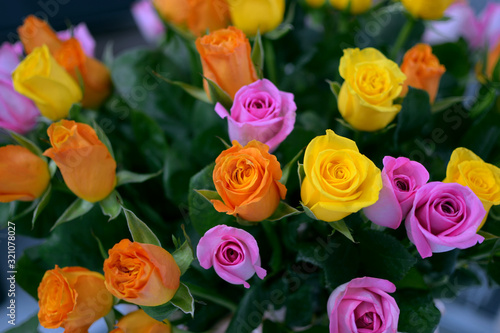 bunch of orange, pink and yellow roses