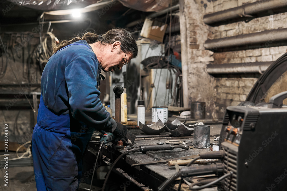 locksmith processes the workpiece using an angle grinder locksmith processes the workpiece using an angle grinder