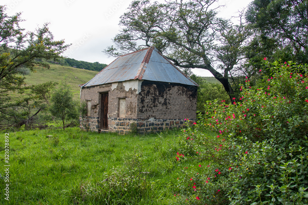 Abandoned Tumbledown Ruins, Buildings With Bright Coloured Plants In The Drakensberg Mountains, South Africa