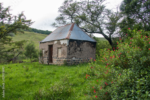 Abandoned Tumbledown Ruins, Buildings With Bright Coloured Plants In The Drakensberg Mountains, South Africa