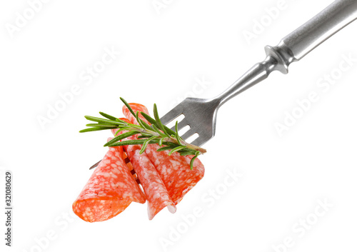 Thin salami slices and rosemary on fork