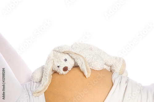 Happy pregnant girl lies on white background © Kostia