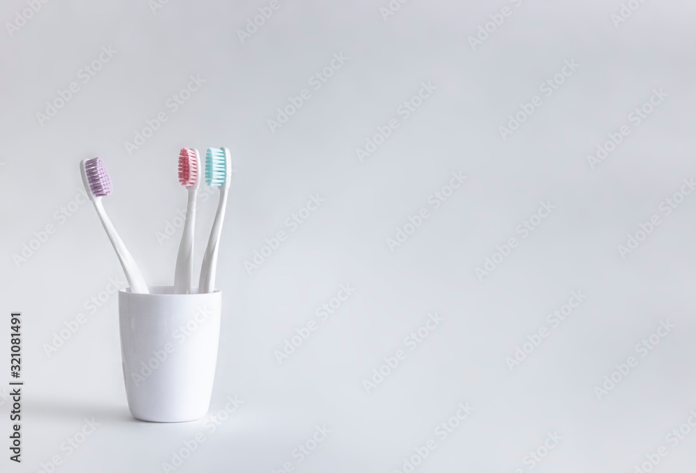 on a white background stands a white glass with a white tooth copy space on a white background stands a white glass with a white tooth copy space