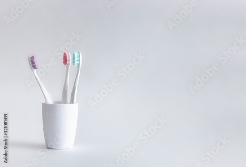 on a white background stands a white glass with a white tooth copy space