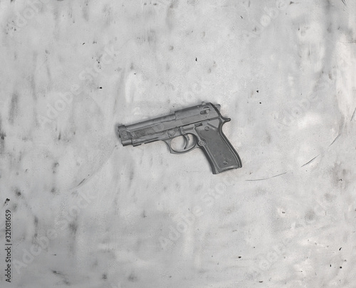 silver pistol on a metal background