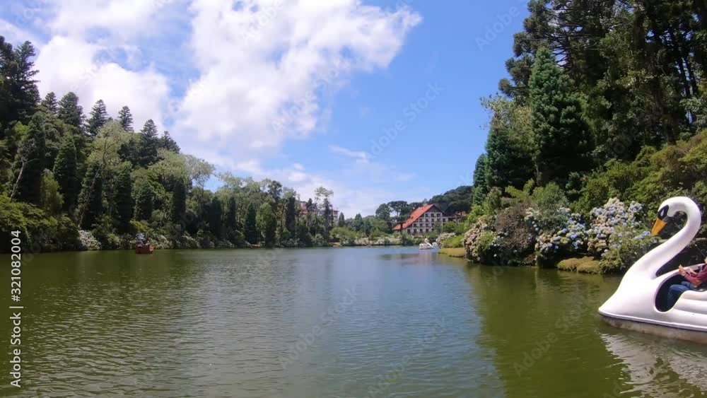 Hyperlapse of tourists at Lago Negro black lake park white swan and pirate ship pedal boat (pedalinho) - Gramado, Canela Rio Grande do Sul, Brazil Hyperlapse of tourists at Lago Negro black lake park white swan and pirate ship pedal boat (pedalinho) - Gramado, Canela Rio Grande do Sul, Brazil