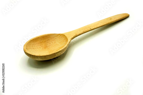 Wooden kitchen utensils on white background. Handcrafted wooden spoon.