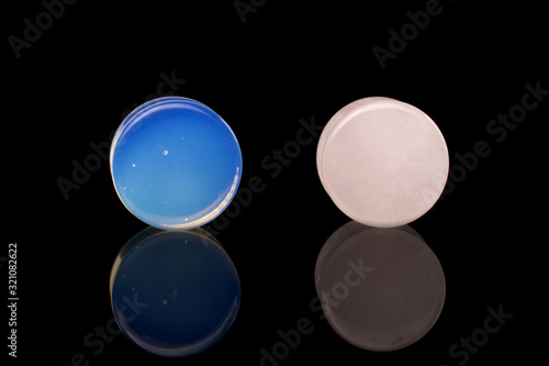 Group of two whole blue white plug isolated on black glass