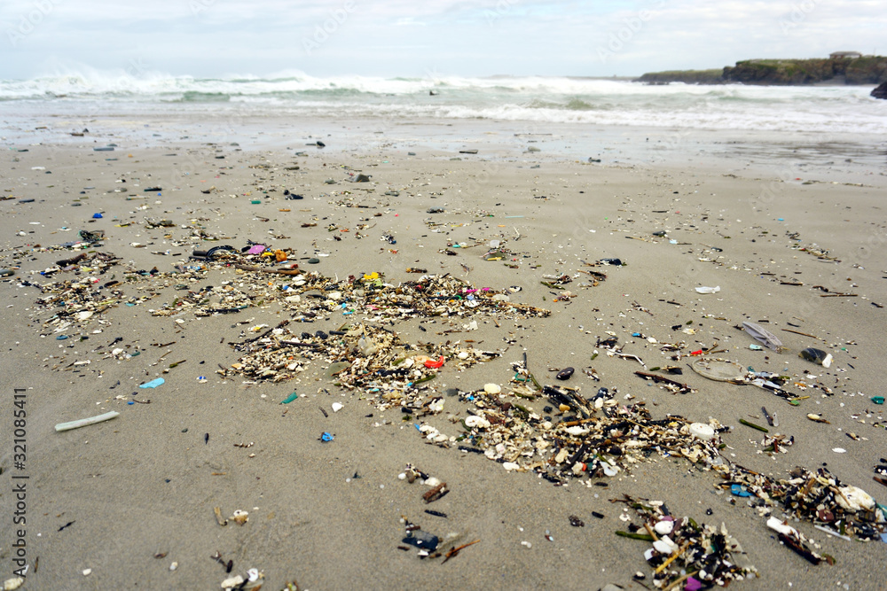 Low tide shows plastics and rubbish over the sand of a beach in As illas beach, Ribadeo, Lugo, Galicia, Spain Low tide shows plastics and rubbish over the sand of a beach in As illas beach, Ribadeo, Lugo, Galicia, Spain