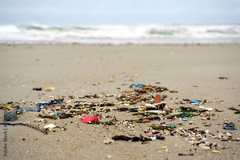 Low tide shows plastics and rubbish over the sand of a beach in As illas beach, Ribadeo, Lugo, Galicia, Spain Low tide shows plastics and rubbish over the sand of a beach in As illas beach, Ribadeo, Lugo, Galicia, Spain