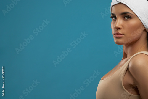 Woman with towel on head posing.