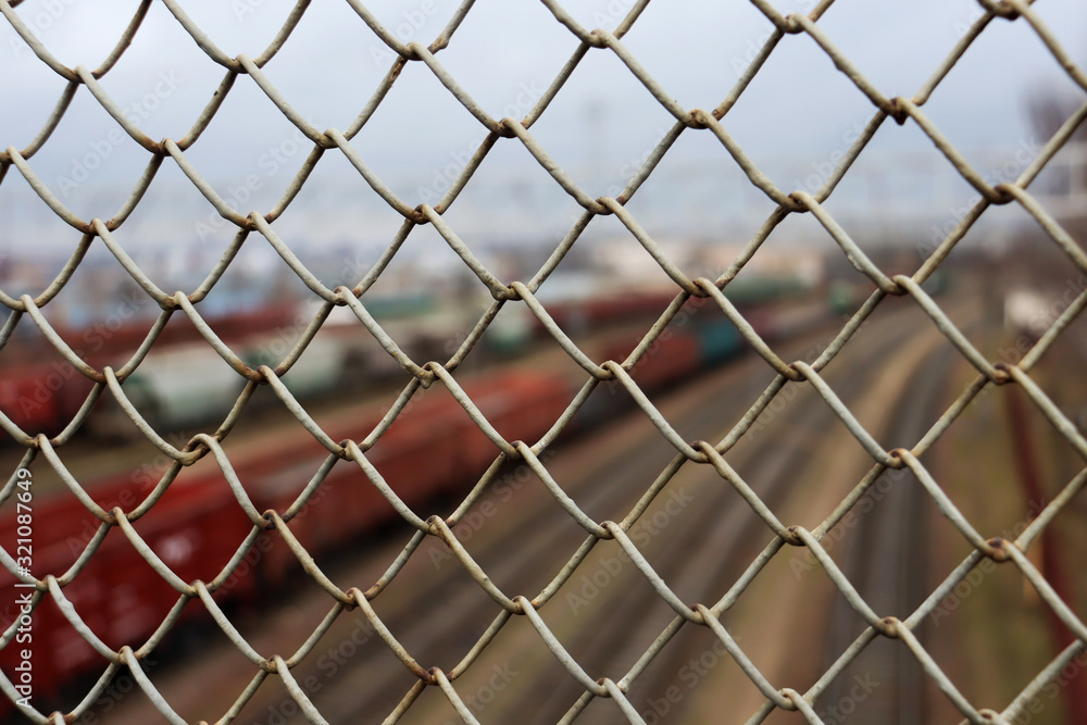 Fototapeta premium Mesh on the background of the railway and railway tracks