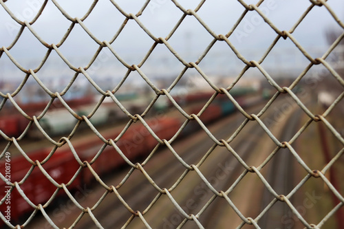 Mesh on the background of the railway and railway tracks
