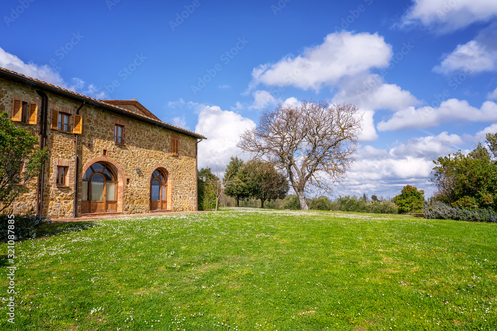 Amazing spring landscape with typical old stone house in Tuscany, Italy