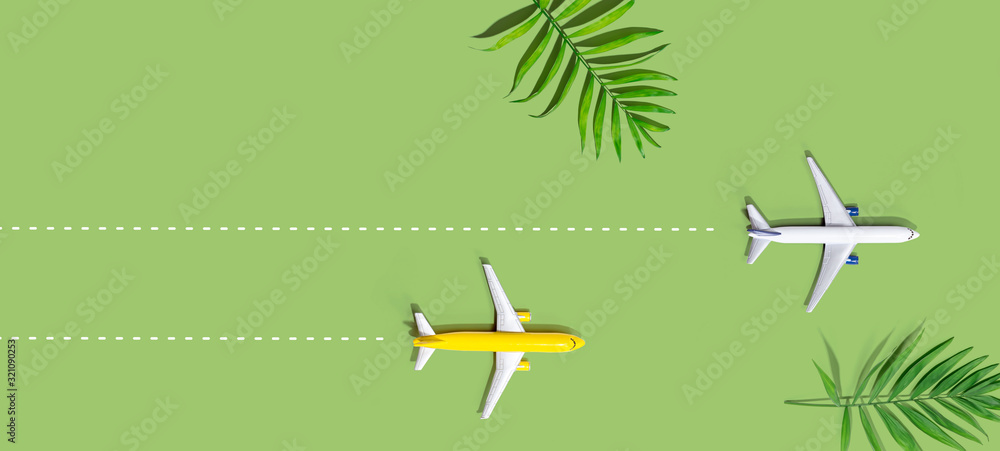 Flights booking and reservation theme with two miniature airplanes Flights booking and reservation theme with two miniature airplanes