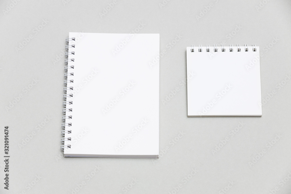 Blank notebook or notepad on grey desk background Blank notebook or notepad on grey desk background