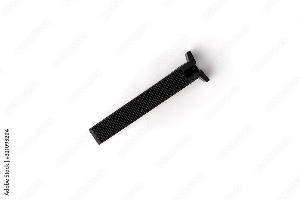 Tile levelling system. Plastic wedges isolated on white background. Tile levelling system. Plastic wedges isolated on white background.
