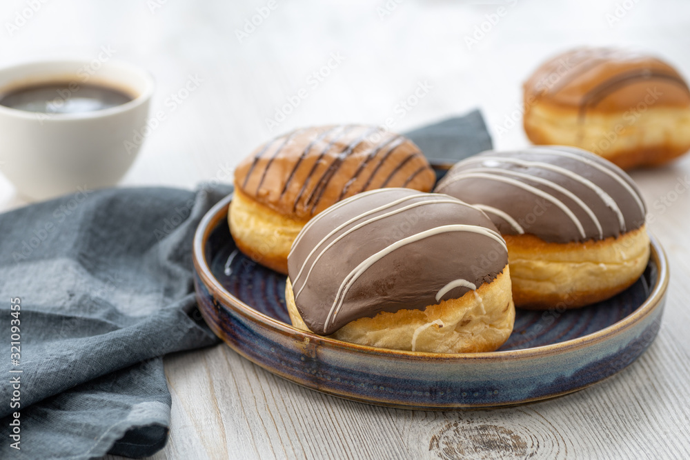 Donut or bun made from sweet yeast dough stuffed with chocolate or cream with icing. Confectionery - Berliner Pfannkuchen.