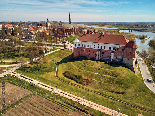 Beautiful panoramic aerial drone view to the Sandomierz Royal Castle - medieval structure in Sandomierz, Poland - was built on a slope of Vistula River by Casimir III the Great in the 16th century photo