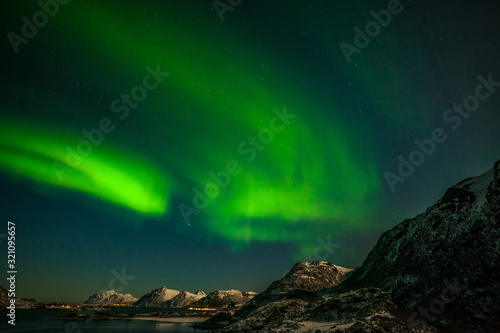 aurora borealis , amazing northern lights over the mountains in the North of Europe - Lofoten islands, Norway © Tatiana