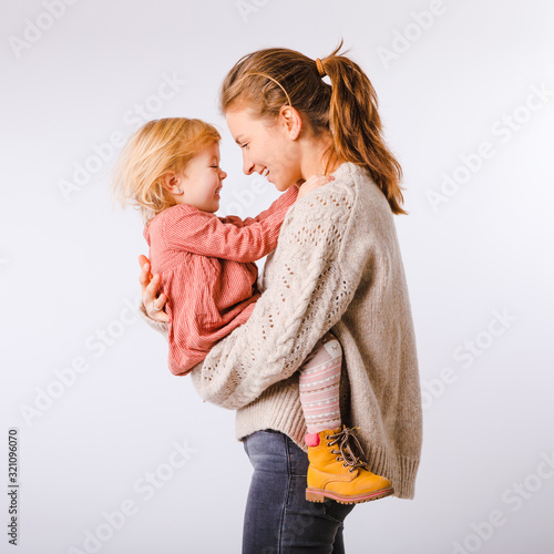 Mama and her little daughter on a white background. Mothers Day.