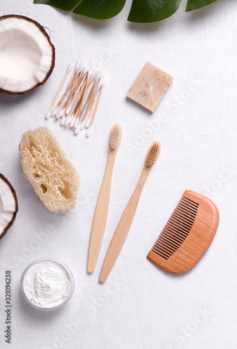 bath accessories on a white background. in the center are bamboo toothbrushes. vertical photo. zero waste concept.