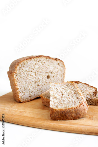 Rye and wheat bread. A piece of bread. A loaf of bread on a cutting board. Isolated image. Food