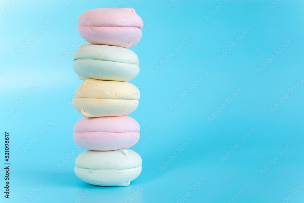 Air marshmallows in pastel shades. A gentle marshmallows. A gentle zephyr on a blue background. Marshmallows in a light key. Air marshmallows in pastel shades. A gentle marshmallows. A gentle zephyr on a blue background. Marshmallows in a light key.