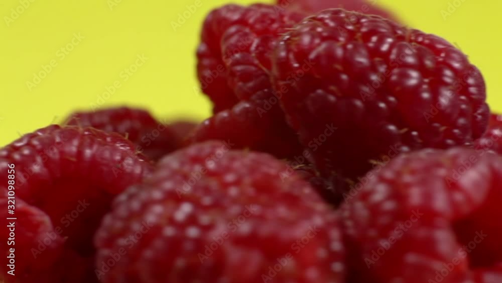 Raspberry rotation over yellow background. Fresh raspberries are spinning in a circle on a yellow background. Raspberry rotation over yellow background. Fresh raspberries are spinning in a circle on a yellow background.