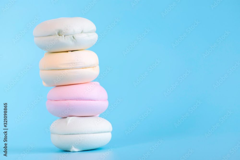 Air marshmallows in pastel shades. A gentle marshmallows. A gentle zephyr on a blue background. Marshmallows in a light key. Air marshmallows in pastel shades. A gentle marshmallows. A gentle zephyr on a blue background. Marshmallows in a light key.