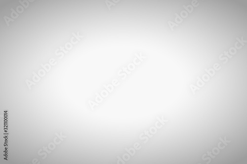 Empty grey blurred background with radial gradient.
