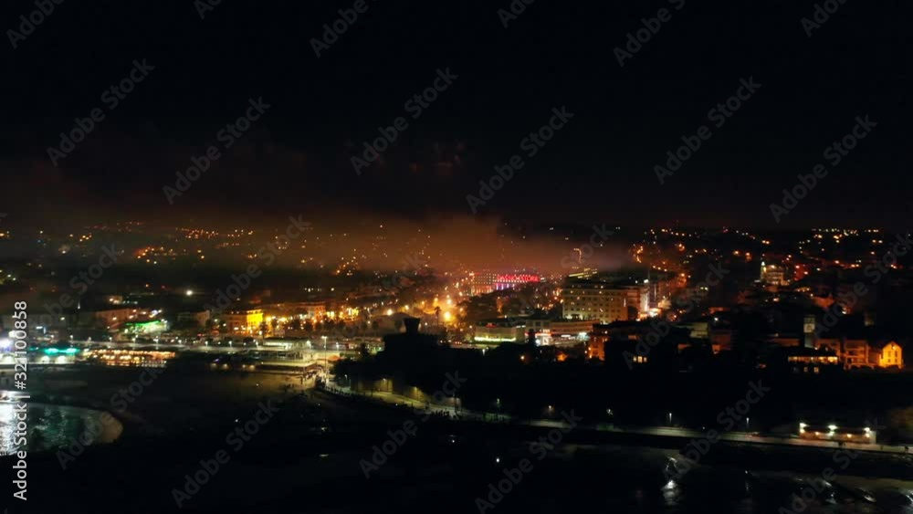 Aerial, tracking, drone shot, of fireworks at the coast of Lisbon, at night time, New year evening, in Estoril, Portugal Aerial, tracking, drone shot, of fireworks at the coast of Lisbon, at night time, New year evening, in Estoril, Portugal