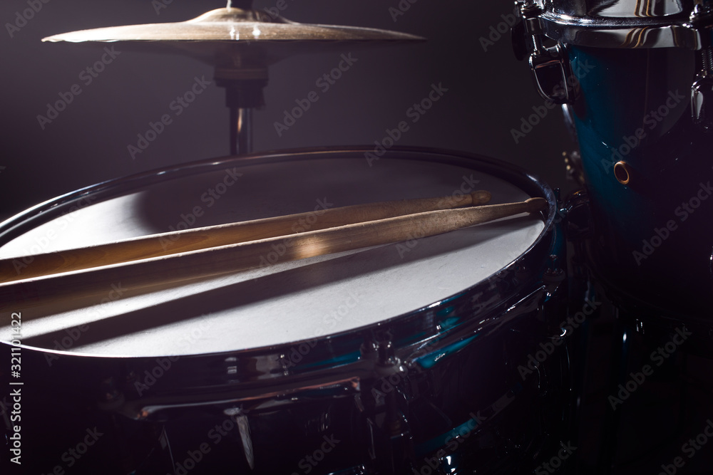Musical instruments drum kit, flash of light, a beautiful light in the background with copy space Musical instruments drum kit, flash of light, a beautiful light in the background with copy space