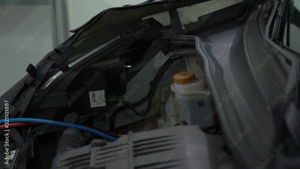 Checking car hood open at service station with flashlight internal parts engine inside of the machine vehicle motor repair camera movement Checking car hood open at service station with flashlight internal parts engine inside of the machine vehicle motor repair camera movement