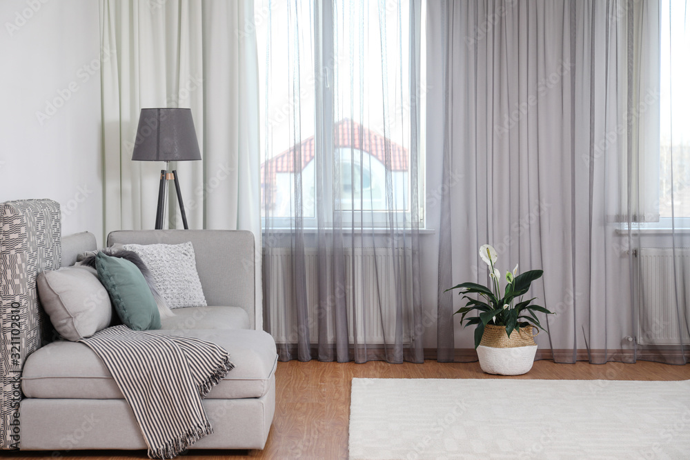 Naklejka premium Window with stylish curtains in living room interior